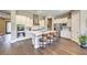 Open kitchen with white cabinets, stainless steel appliances, and a center island with bar seating at 2509 Chateau Napoleon Dr, Henderson, NV 89044