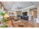 Bright living room showcasing a stone fireplace, large television, and hardwood flooring at 2509 Chateau Napoleon Dr, Henderson, NV 89044