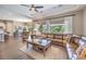 Spacious living room with hardwood floors, leather sofa, and views to the outside at 2509 Chateau Napoleon Dr, Henderson, NV 89044