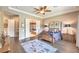Stylish main bedroom boasts hardwood floors, tray ceilings, and ensuite bathroom at 2509 Chateau Napoleon Dr, Henderson, NV 89044
