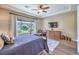 Stylish main bedroom boasts hardwood floors, tray ceilings, and large window views at 2509 Chateau Napoleon Dr, Henderson, NV 89044