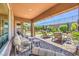 Inviting covered patio featuring ample seating, manicured landscaping, and views of the backyard at 2509 Chateau Napoleon Dr, Henderson, NV 89044