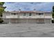 Exterior view of condo building with garages, balconies, and desert landscaping at 2633 S Durango Dr # 202, Las Vegas, NV 89117