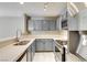 Updated kitchen featuring gray cabinets, stainless steel appliances and white quartz countertops at 2633 S Durango Dr # 202, Las Vegas, NV 89117