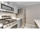 Updated kitchen featuring gray cabinets, stainless steel appliances and quartz countertops at 2633 S Durango Dr # 202, Las Vegas, NV 89117