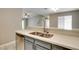Kitchen sink featuring quartz countertops, stainless steel appliances and a view into the living room at 2633 S Durango Dr # 202, Las Vegas, NV 89117