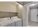 The laundry room includes a washer, dryer, and overhead shelf at 2633 S Durango Dr # 202, Las Vegas, NV 89117