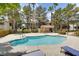 Community pool area with lounge chairs, mature trees, and beautiful landscaping at 2633 S Durango Dr # 202, Las Vegas, NV 89117