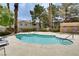 Beautiful community pool surrounded by lush greenery and palm trees at 2633 S Durango Dr # 202, Las Vegas, NV 89117