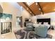 Serene main bedroom featuring a high ceiling, a plush bed, modern decor, and a view of the ensuite at 2845 Queens Courtyard Dr, Las Vegas, NV 89109