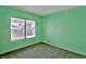 A bright green empty room with a view to the yard with a brown fence outside the window at 2865 Destino Ln, Henderson, NV 89074