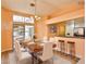 Cozy dining room featuring a modern table set and barstool seating at the kitchen counter at 2865 Destino Ln, Henderson, NV 89074