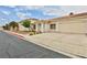 Inviting single-story home with a two-car garage, desert landscaping, and tiled roof at 2865 Destino Ln, Henderson, NV 89074