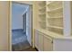 Hallway with built-in shelving and cabinets, leading to a bedroom with mirrored closets at 2865 Destino Ln, Henderson, NV 89074