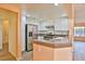 Bright kitchen features stainless steel appliances and a breakfast bar at 2865 Destino Ln, Henderson, NV 89074