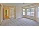 Spacious primary bedroom featuring large windows for ample natural light and neutral gray carpeting at 2865 Destino Ln, Henderson, NV 89074