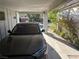 View under a carport, showcasing parking space and glimpse of the neighborhood street with landscaping at 2989 Bel Air Dr, Las Vegas, NV 89109