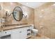 Well-lit bathroom with granite counters, a large oval mirror, and tile flooring at 30 Strada Di Villaggio # 118, Henderson, NV 89011