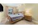 Cozy bedroom featuring a queen-sized bed, a large window, and natural lighting at 30 Strada Di Villaggio # 118, Henderson, NV 89011