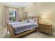 Comfortable bedroom with a queen bed, side table, and view of the outside at 30 Strada Di Villaggio # 118, Henderson, NV 89011