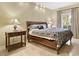 Bright bedroom featuring a queen bed with end tables and travertine floors at 30 Strada Di Villaggio # 118, Henderson, NV 89011