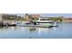 Picturesque scene of a dock with a large white yacht and various other boats and watercraft at 30 Strada Di Villaggio # 118, Henderson, NV 89011