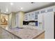 Bright kitchen with granite countertops, white appliances, and ample cabinet space at 30 Strada Di Villaggio # 118, Henderson, NV 89011