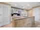 Spacious kitchen featuring an island with countertop, white cabinetry, and modern appliances at 30 Strada Di Villaggio # 118, Henderson, NV 89011