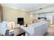 Open living room with marble floors, a kitchen view, and bright lighting at 30 Strada Di Villaggio # 118, Henderson, NV 89011
