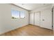 Bright bedroom with wood floors, large window and a closet with sliding doors at 307 Balsa St, Henderson, NV 89002