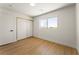 Cozy bedroom with wood floors, ample light, and closet with sliding doors at 307 Balsa St, Henderson, NV 89002