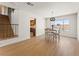 Open dining area with hardwood floors, modern chandelier, and pool view at 307 Balsa St, Henderson, NV 89002