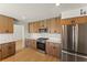 Updated kitchen featuring wood cabinets, stainless steel appliances, and marble countertops at 307 Balsa St, Henderson, NV 89002