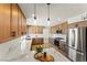 Modern kitchen with wood cabinets, stainless steel appliances, and pendant lighting at 307 Balsa St, Henderson, NV 89002
