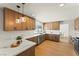 Well-lit kitchen with stainless steel appliances, wood cabinets and marble countertops at 307 Balsa St, Henderson, NV 89002