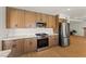 Kitchen with stainless steel appliances, wood cabinets, and marble countertops at 307 Balsa St, Henderson, NV 89002
