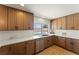 Bright kitchen with stainless steel appliances, wood cabinets, and marble countertops at 307 Balsa St, Henderson, NV 89002