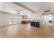 Bright open-concept living room featuring wood floors, ceiling fan, and direct access to the backyard and pool at 307 Balsa St, Henderson, NV 89002