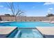 Inviting pool with raised hot tub, desert landscaping, and a concrete surround at 307 Balsa St, Henderson, NV 89002