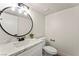 Modern powder room with marble countertop, sleek fixtures, decorative mirror, and contemporary design at 307 Balsa St, Henderson, NV 89002