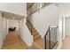 Modern staircase with wooden steps, black iron railing, and abundant natural light, creating an inviting entrance at 307 Balsa St, Henderson, NV 89002