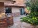 Cozy backyard patio featuring stone flooring, lush greenery, seating area, and unique architectural details for relaxation at 3167 El Cedro Cir, Las Vegas, NV 89121