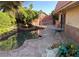 Charming backyard pond with lush landscaping, stone patio, and tranquil setting at 3167 El Cedro Cir, Las Vegas, NV 89121