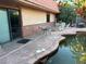 Backyard with a large pond and access to the house through sliding glass doors at 3167 El Cedro Cir, Las Vegas, NV 89121