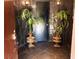 Grand entryway with black slate walls, decorative plants, and a modern keyless entry system at 3167 El Cedro Cir, Las Vegas, NV 89121