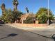 Corner lot with a red tile roof, mature trees, well-maintained landscaping, and a front yard fence at 3167 El Cedro Cir, Las Vegas, NV 89121
