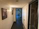 Hallway with tiled flooring and unique wall art, leading to an adjacent room with natural lighting and a view at 3167 El Cedro Cir, Las Vegas, NV 89121