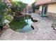 Serene backyard with a charming pool, waterfall feature, and stone patio, perfect for outdoor relaxation and entertainment at 3167 El Cedro Cir, Las Vegas, NV 89121