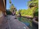 Tranquil backyard oasis with a custom-designed pool surrounded by lush landscaping and patio space at 3167 El Cedro Cir, Las Vegas, NV 89121