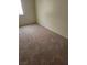 Empty bedroom with worn gray carpet and a window at 3237 Perching Bird Ln, North Las Vegas, NV 89084